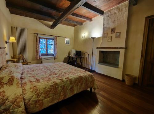 a bedroom with a large bed and a fireplace at Le 5 Frecce in Cavour