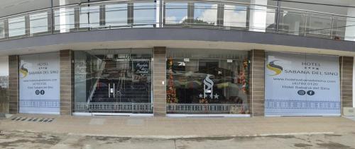 a store front of a building with windows at Hotel Sabana del Sinu By GEH Suites in Montería