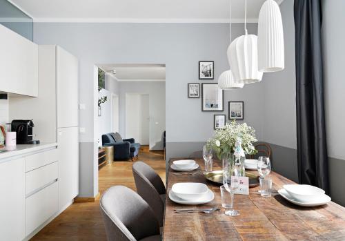 a kitchen and dining room with a table and chairs at numa I Nora Apartments in Salzburg