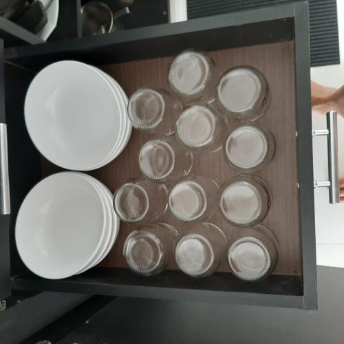 a bunch of plates are in a box at Casa Vitória em barra de jacuipe in Campos