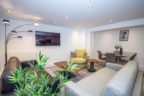 a living room with a couch and a table at The Sandringham Suite in Plymouth