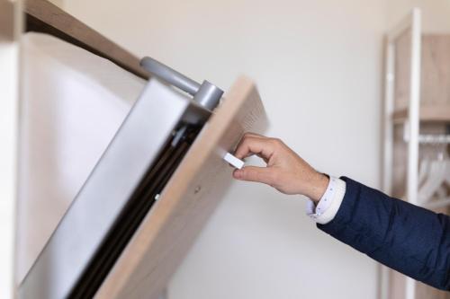 a person holding a thermometer in front of a refrigerator at Life Hotel Seaview & Spa in Porto Recanati
