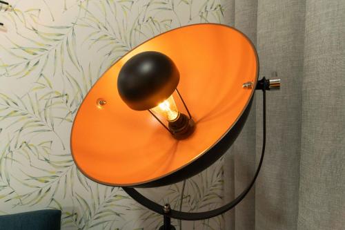 an orange lamp on the side of a wall at HOME@abrantes in Abrantes