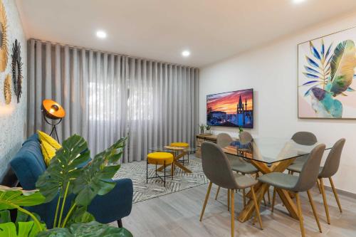a living room with a dining room table and chairs at HOME@abrantes in Abrantes