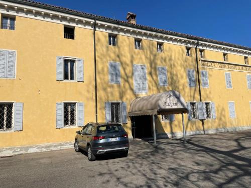 a car parked in front of a yellow building at Albergo Ligabue in Gualtieri
