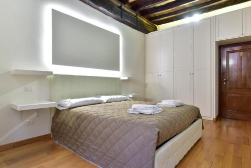 a bedroom with a bed with two pillows on it at Elite Rome apartments 2 in Rome