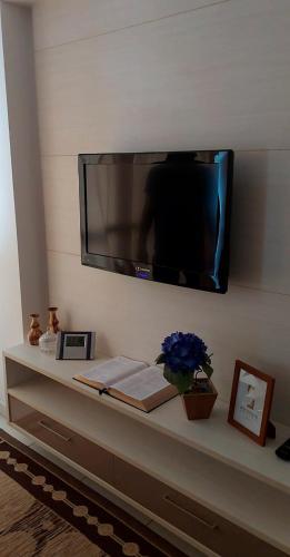 a flat screen tv hanging on a wall at Residencial Amazonia Apto 1205 in João Pessoa