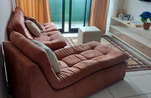 a brown leather couch sitting in a living room at Residencial Amazonia Apto 1205 in João Pessoa