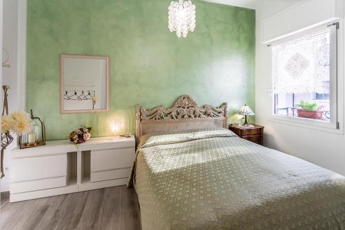 a bedroom with a bed and a chandelier at Da Pina e Quinto Home in Morciano di Romagna