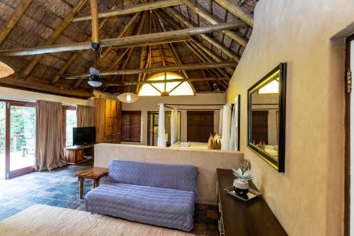 a living room with a couch and a table at Fish Eagle Manor in East London