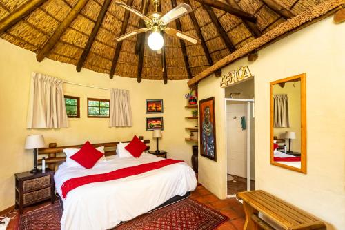 a bedroom with a bed and a ceiling fan at Fish Eagle Manor in East London