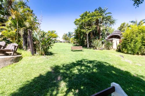 a grassy yard with a bench and a gazebo at Fish Eagle Manor in East London