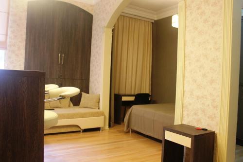 a hotel room with a bed and a chair in it at Vachnadze Apartment in Tbilisi City