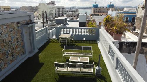 a balcony with benches and grass on a building at Navona Studios in San Juan