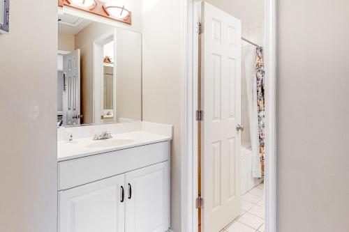 a white bathroom with a sink and a mirror at Sea Colony - 56032 Great Pine in Bethany Beach
