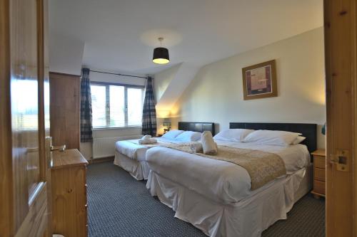 Postel nebo postele na pokoji v ubytování Village Lodge - Carlingford