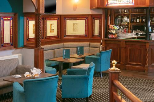 a restaurant with tables and chairs and a bar at Woodlands Hotel, BW Signature Collection in Dundee