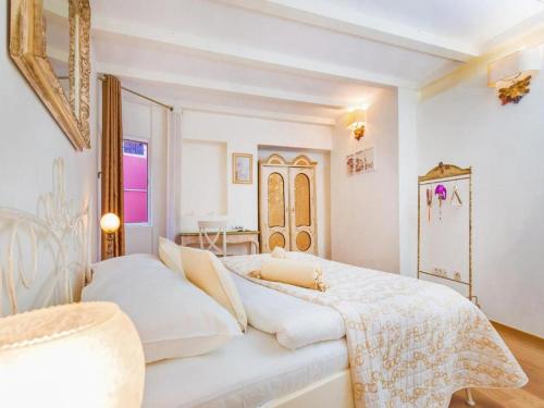 a white bedroom with a large bed and a window at Heritage Hotel Villa Valdibora in Rovinj