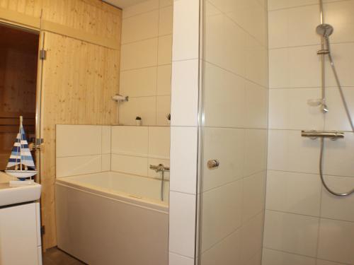 a bathroom with a shower and a bath tub at Sielhuus 10 in Fedderwardersiel