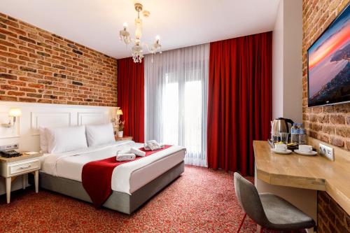 a hotel room with a bed and red curtains at La Porte de Taksim in Istanbul