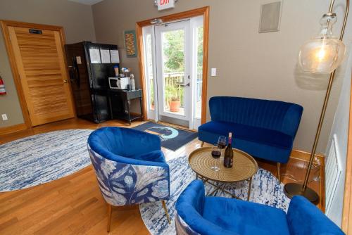 a living room with blue chairs and a table at The Inn on Pamlico Sound in Buxton