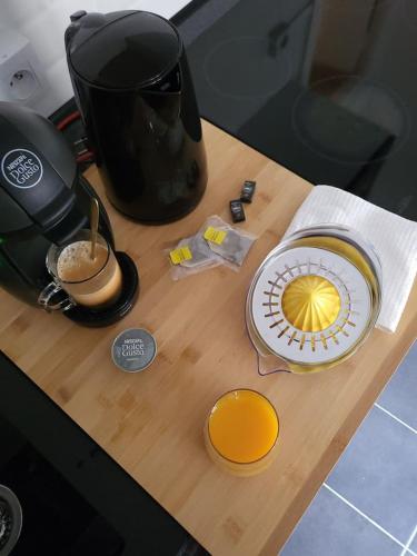 a counter top with a coffee pot and a frisbee on it at Appart' Studio cooconing - Champs Elysées - NETFLIX in Maisons-Laffitte