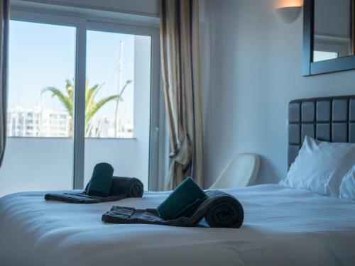 a bed with two wheels on it with a window at Lagos Marina View studio apartment on main avenue in Lagos