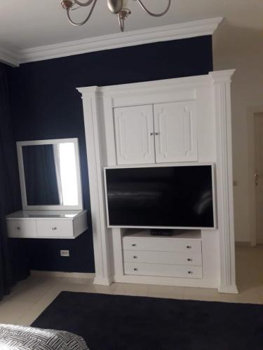 a large white cabinet with a television in it at Stella Di Mare Ain Sokhna Beautiful Luxurious Villa in Ain Sokhna