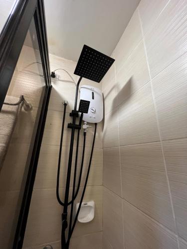 a bathroom with a toilet and a light on the wall at Tagaytay Hampton Villa in Tagaytay