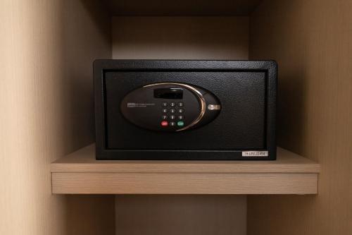 a small television sitting on a shelf in a wall at DM Hoteles Tacna in Tacna