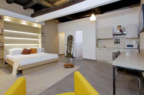 a living room with a bed and a kitchen at Trastevere Suites & Spa in Rome