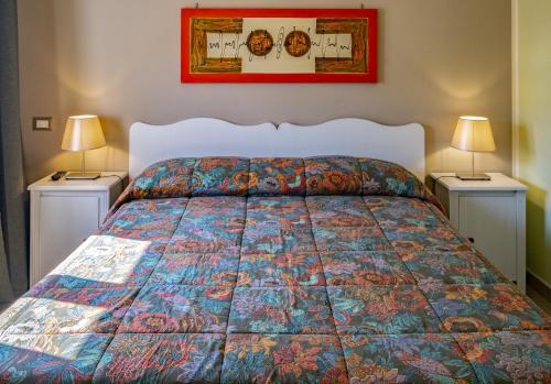 a bedroom with a bed with two night stands at B&B San Trifone in Adelfia