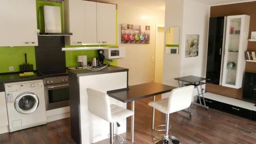 a kitchen with a table and chairs in a room at Wohnen bei Anke in Wermelskirchen