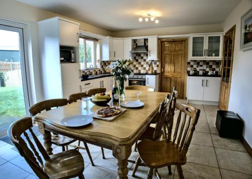 - une salle à manger avec une table et des chaises en bois dans l'établissement Village Lodge - Carlingford, à Carlingford