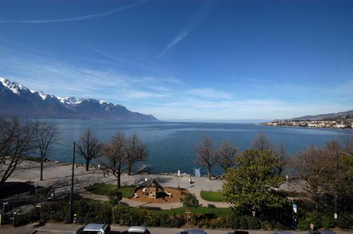 a view of a large body of water with mountains at Hotel Parc & Lac in Montreux