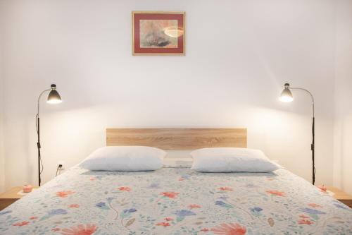 a bedroom with a bed with two pillows at Apartman Vito in Labin