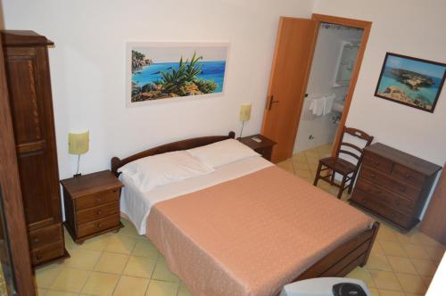 A bed or beds in a room at Le Anfore Appartamenti