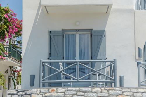a door on the side of a white building at Naxian Althea in Agia Anna Naxos