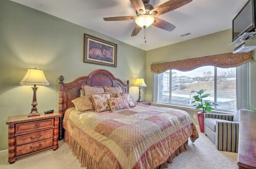 a bedroom with a bed and a ceiling fan at Breezy Lake Ozark Escape Dock, Slip and Pool! in Lake Ozark