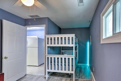 a room with a bunk bed and a blue wall at Lake Erie Waterfront Home with Sunroom and Yard! in Erie