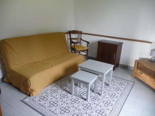 a bedroom with a bed and two tables on a rug at Gîte des Forces - Limousin - Haute Vienne in Saint-Bazile