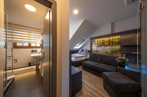 a living room with a couch and a bed at Parkhotel Plauen in Plauen