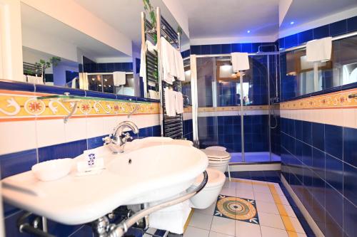 a bathroom with a sink and a toilet at Hotel Croce Di Amalfi in Amalfi