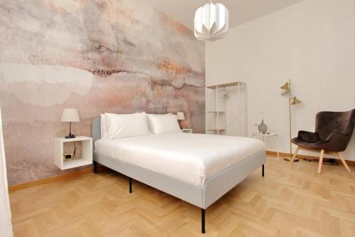 a bedroom with a white bed and a chair at Take me Rome - Roman Forum Apartments in Rome