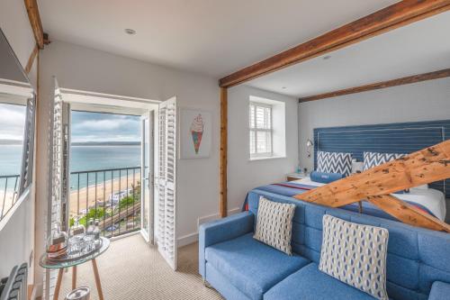 a living room filled with furniture and a window at St Ives Harbour Hotel & Spa in St Ives