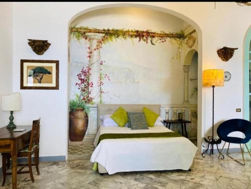 a bedroom with a bed and a table and a desk at Villa La Terrazza Suites in Sorrento