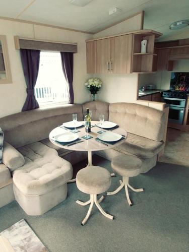 a living room with a table and chairs and a couch at Len's Getaway Tattershall Lakes in Tattershall