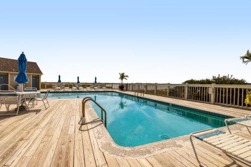 a large swimming pool with a wooden deck at Kings Grant -- 40058 Grant Dr #46 in Fenwick Island