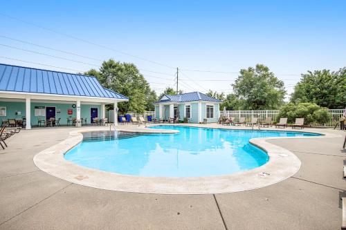 a swimming pool with blue water in front of a building at Millville by the Sea- 23923 Pembroke Lane in Millville