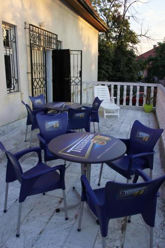 a group of blue tables and chairs on a patio at Mosaico Alfetta Hostel in Timişoara